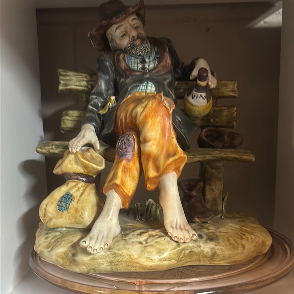 Charming Figurine of a Resting Man with Orange Pants